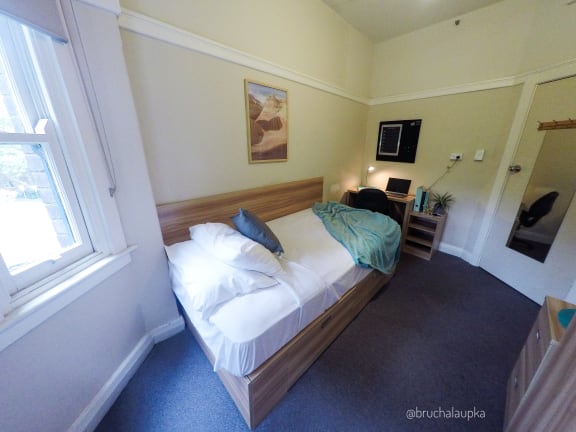 a bedroom with a bed and a window