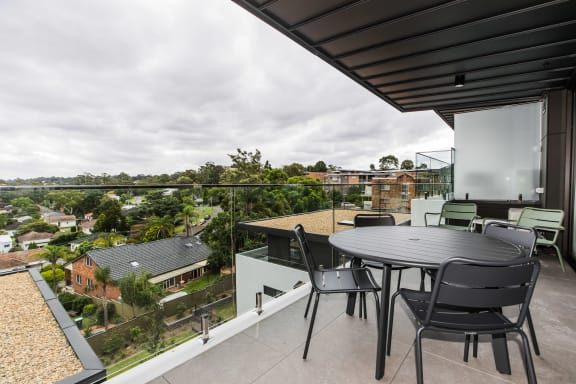 a patio with a table and chairs on a balcony