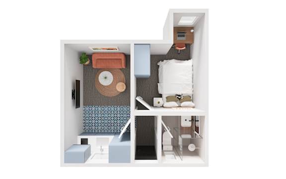 A small room with a bed, a desk, and a chair.