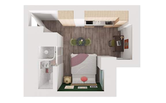 A small bedroom with a bed, nightstand, and a small table.