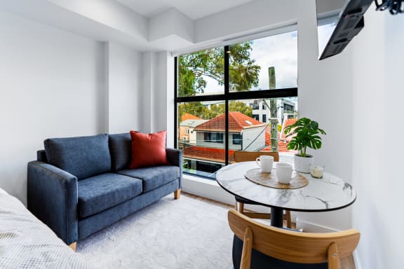 a living room with a couch and a table and a window