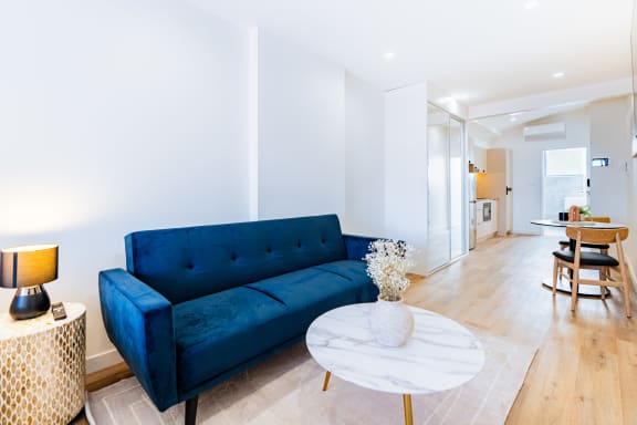 a living room with a blue couch and a coffee table