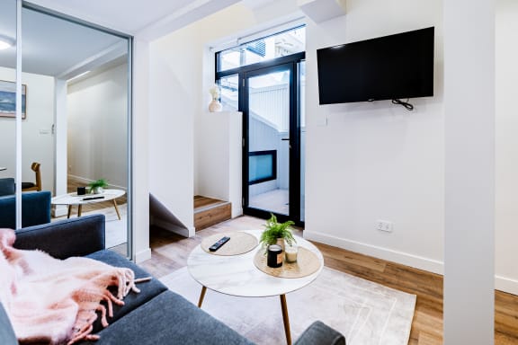 a living room with a couch and a table and a television