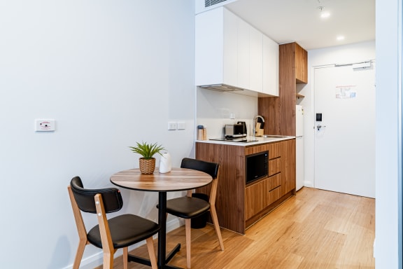 a kitchen and dining area with a table and chairs