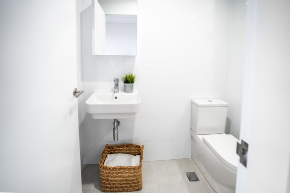 a white bathroom with a toilet and a sink