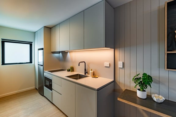 a kitchen with white cabinets and a sink