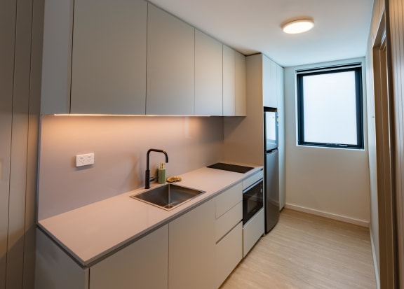 a kitchen with white cabinets and a sink