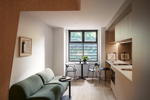 a living room with a couch and a table and a window