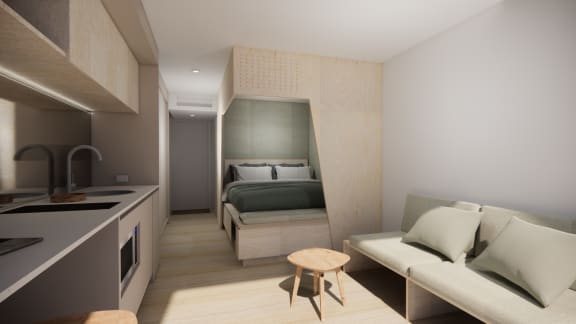 a small apartment with a kitchen and a bed