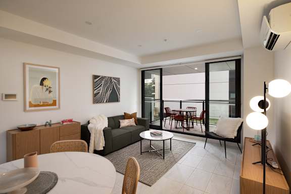 A modern living room with a dining table and chairs.