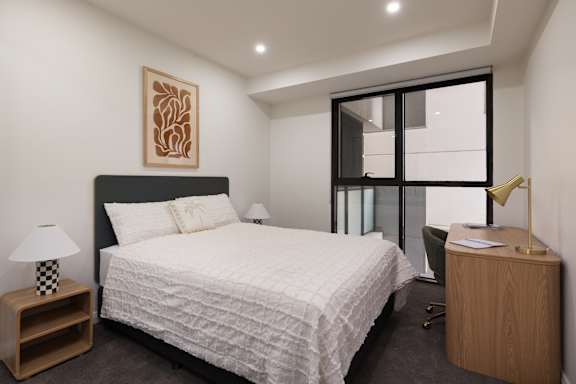 A bedroom with a large bed, a nightstand, and a chair.