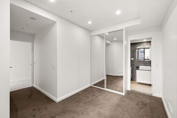 A room with white walls and a carpeted floor.