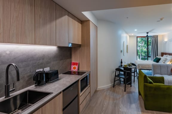 a kitchen and living room with a couch and a table