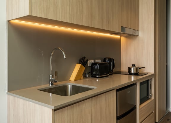 a small kitchen with a sink and a faucet