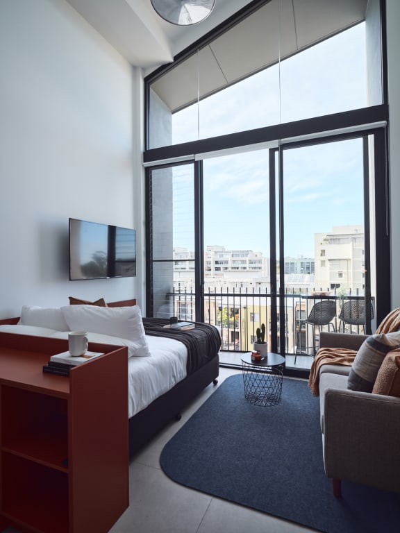 a hotel room with a bed and a large window