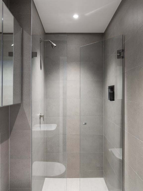 a bathroom with a shower and a toilet in it