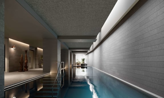 a large swimming pool in the middle of a house with white walls