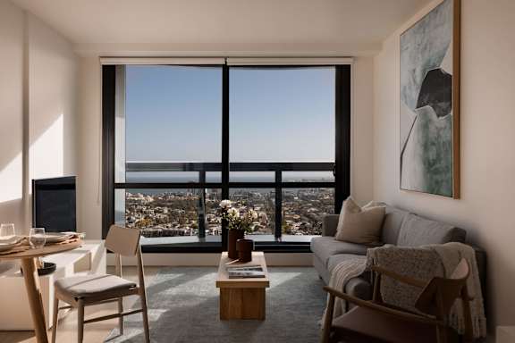 A living room with a view of the city.