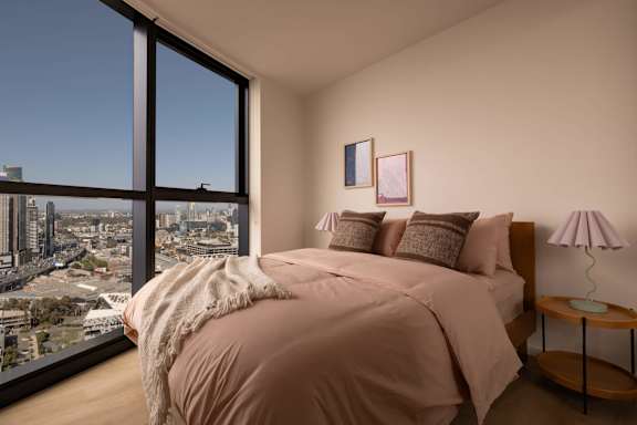 A bedroom with a large bed and a view of the city.