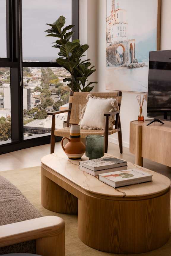 A living room with a large window overlooking a cityscape.