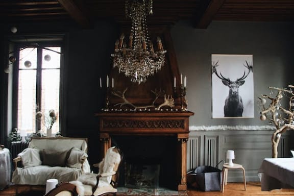 a living room with a chandelier and a fireplace