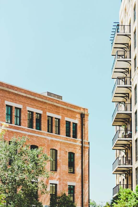 a brick building in front of a blue sky