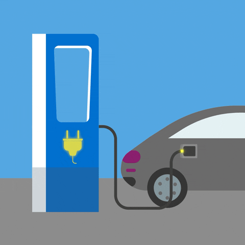 A car is charging at a blue electric vehicle charging station.