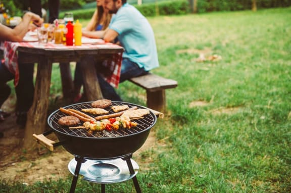 Alt- BBQ area with the bench and friends sitting on it