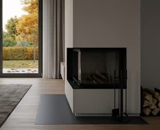 A modern living room with a fireplace and a view of the garden outside.