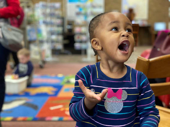 Alt- A Toddler in blue t shirt playing with toys