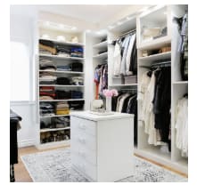 Alt-Spacious walk-in closet with shelves and center isle .