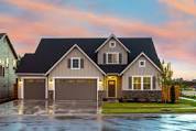 a house on a flooded street with a sunset