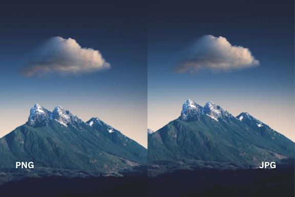 Two mountain peaks with a cloud in the sky.