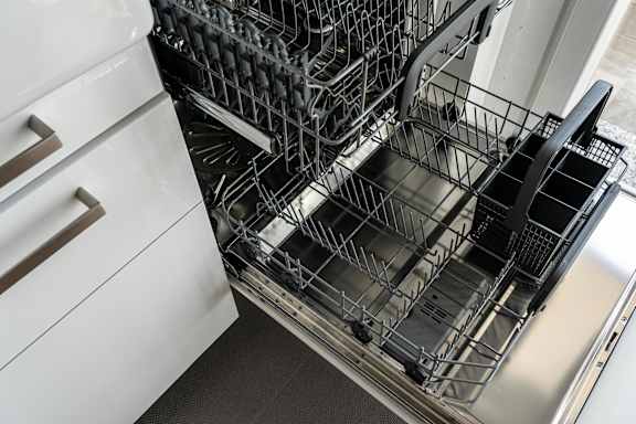 A dishwasher with a full rack of dishes.