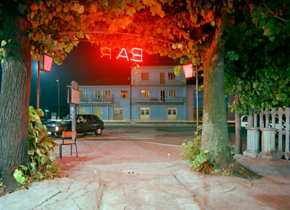 a building with a neon sign at night