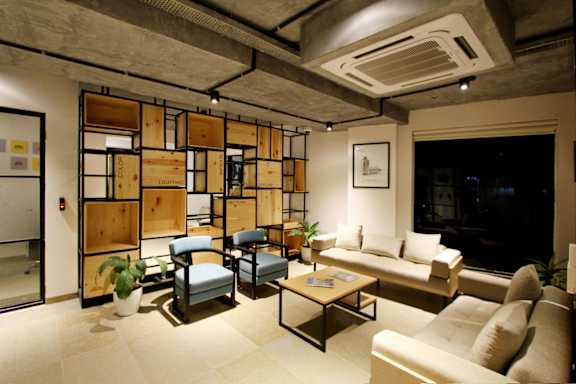 A living room with a couch, chairs, and a coffee table.