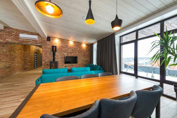 A room with a long wooden table and chairs.
