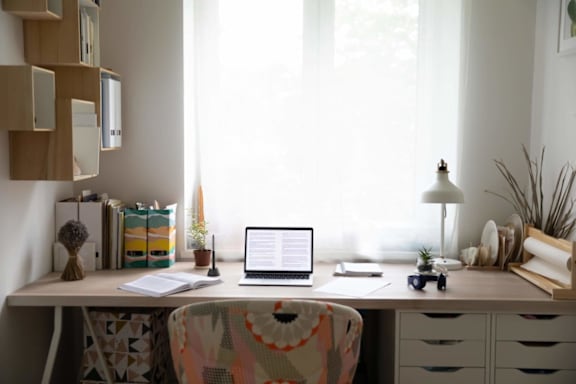 A laptop is open on a desk with a blank screen.
