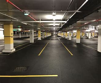 A parking garage with yellow lines on the ground.