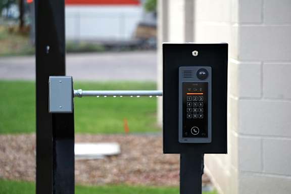 A parking meter with a digital display and a keypad is mounted on a pole.