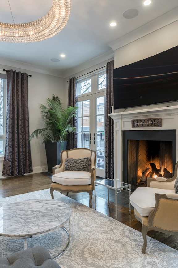 A living room with a fireplace and a chair.