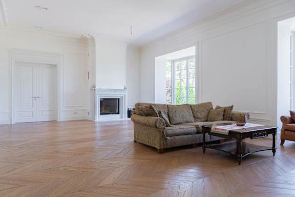 A living room with a couch, chair, and fireplace.