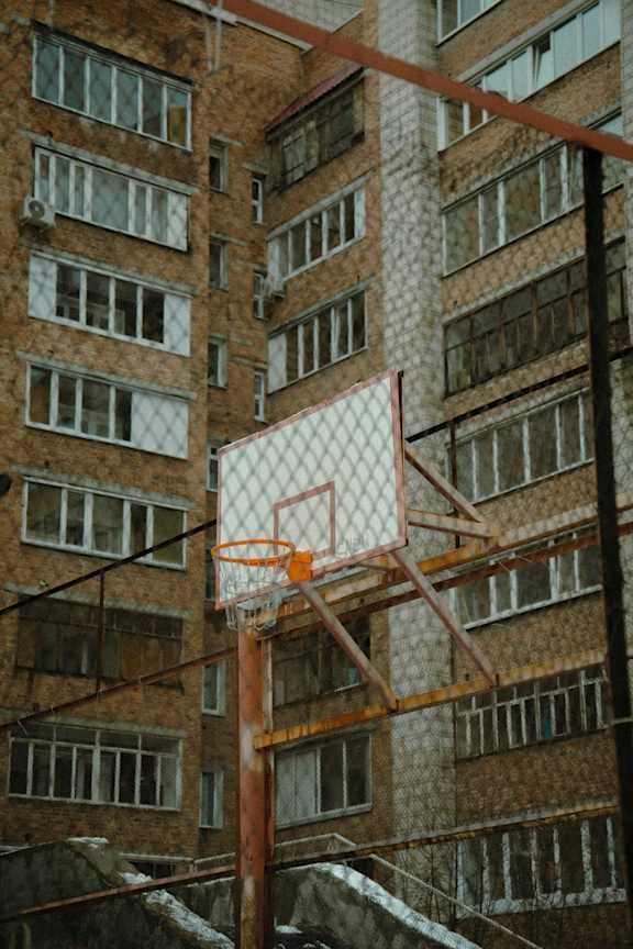 A basketball hoop is attached to a building.