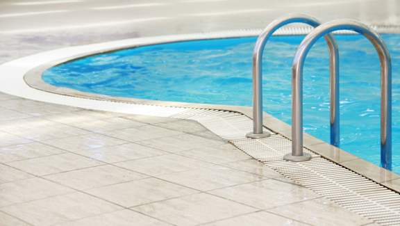 A swimming pool with a metal ladder.