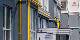 a building with yellow piping on the side of it