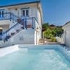 a large swimming pool in front of a house