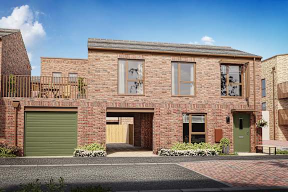 A red brick house with a green garage door.