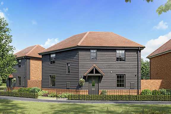 A grey house with a black fence in front.