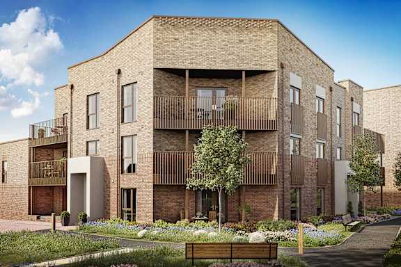 A modern brick building with balconies and a garden in front.