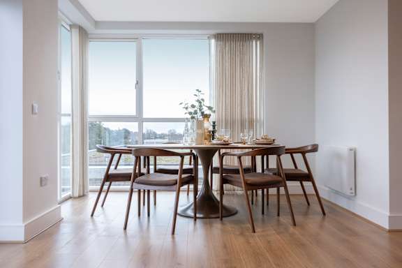 A dining room with a table set for six.